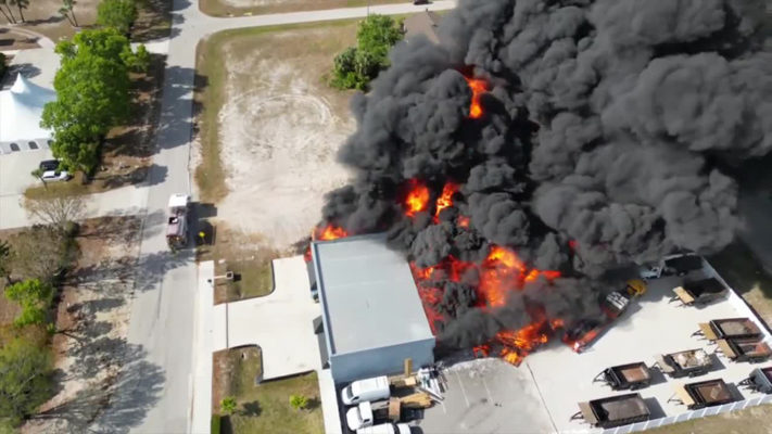 A picture of A Plus Roofing in Cape Coral, Fla. engulfed in flames after a fire ripped through the warehouse and a nearby church.
