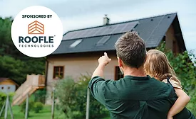 A man and woman looking at their home