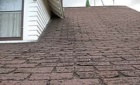 Hanover Insurance Report.jpg A picture of a roof with badly worn shingles.
