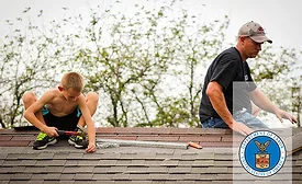 A man and a child on a roof (pictured). Image used under Creative Commons license. Photo by International Labor Organization.