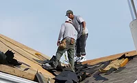 Top 10 Most Dangerous Jobs.jpg Roofers standing on a roof (pictured).