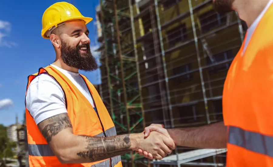 Contractor. construction worker team hands shaking after plan project contract  at construction site, contractor, engineering, partnership, construction concept