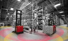 Forklifts facing each other in a factory