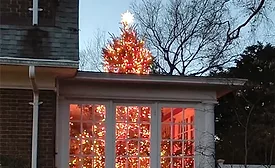 The illusion of a Christmas Tree busting through the roof of a home has gone viral.