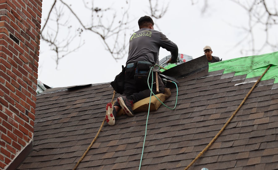 A man wearing safety equipment while working on a roof
