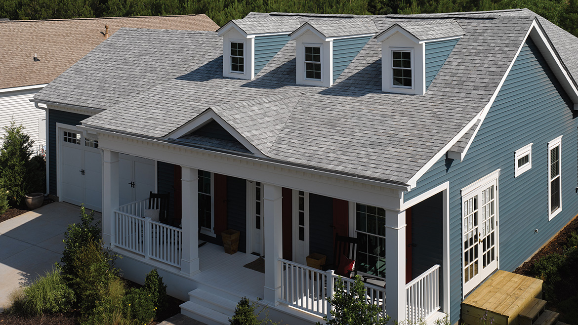 A house with a new roof featuring Solaris shingles by Certainteed