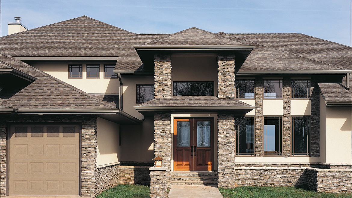 A house with a new roof featuring Solaris shingles by Certainteed