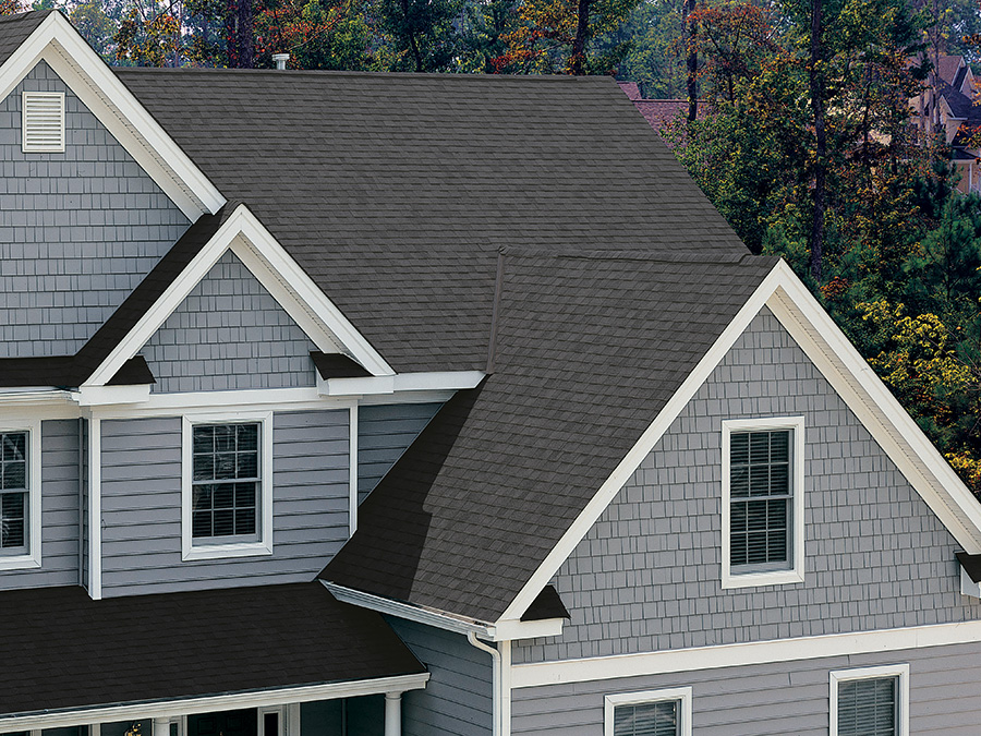 A house with a new roof featuring Solaris shingles by Certainteed