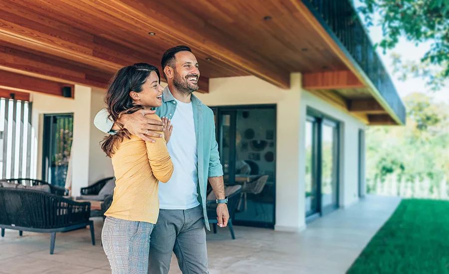 A couple standing in their new home