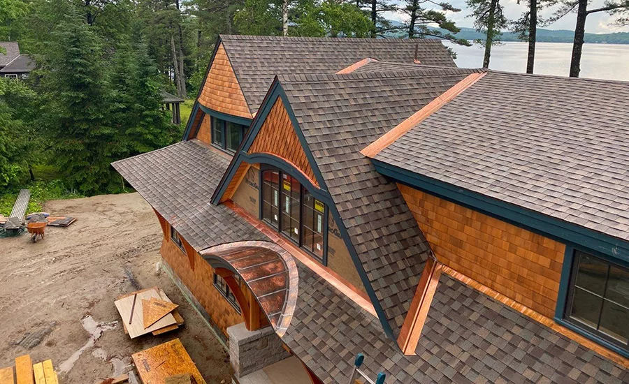The “Asphalt and Copper on the Lake” roofing project from Conde Roofing seamlessly blended asphalt shingles and copper elements to create a stunning and sturdy roof.