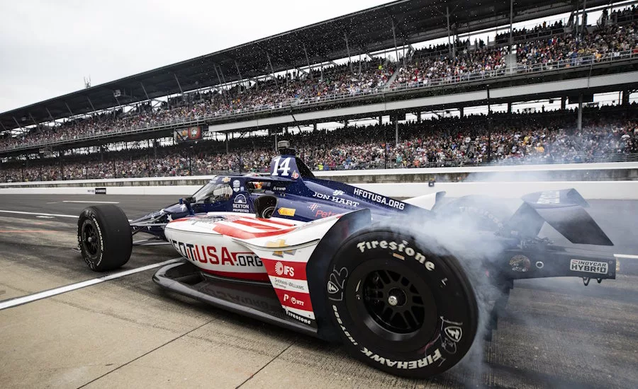 AJ Foyt Race Car with smoking tires on race track