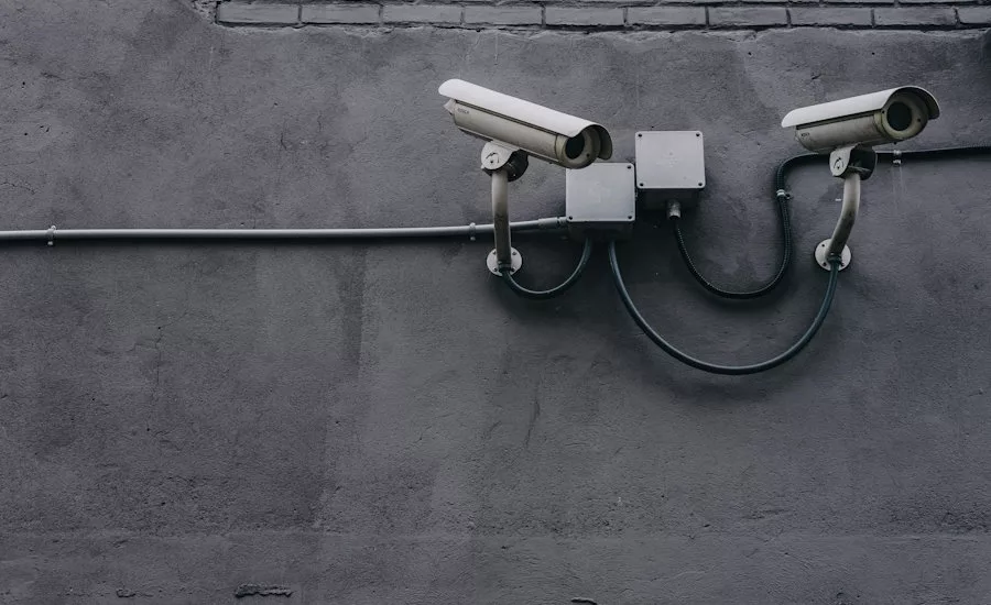 two-white-security-cameras-mounted-on-cement-wall