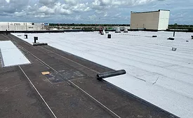 A cover board layer over a Polytherm ISO hot-mopped system laid on the concrete roof deck