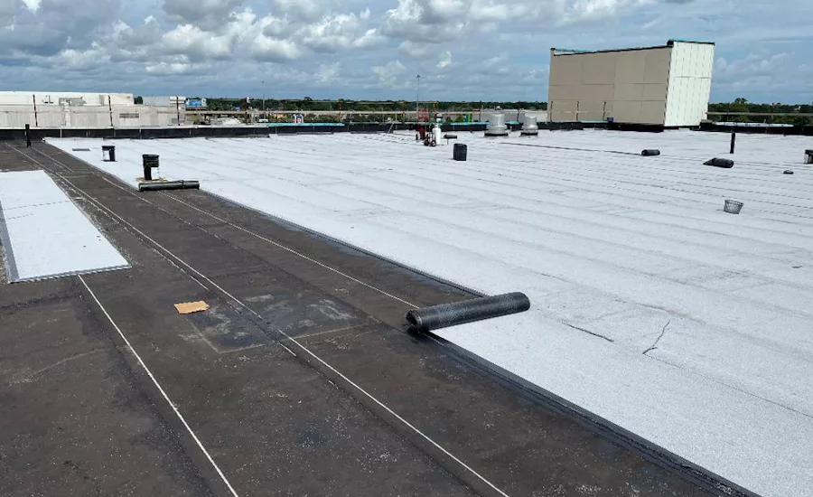 A cover board layer over a Polytherm ISO hot-mopped system laid on the concrete roof deck