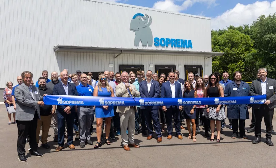 SOPREMA-employees-with-blue-ribbon-in-front-of-Schoolcraft-facility