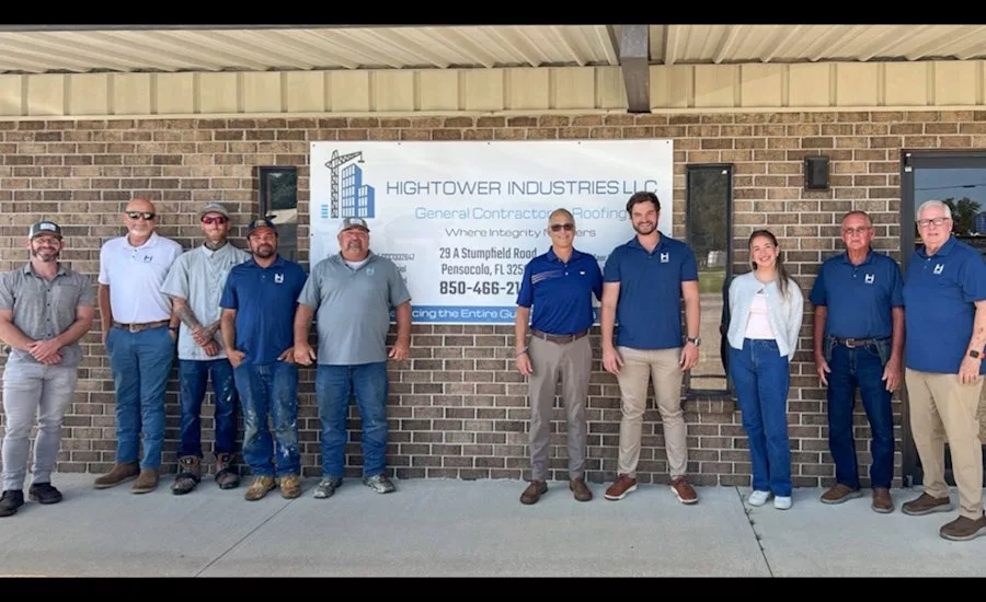 Weather-Shield-and-Hightower-Industries-employees-stand-with-a-Hightower-banner