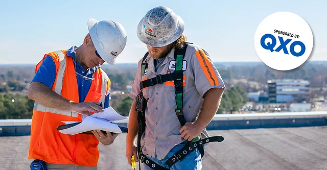 Baker-Roofing-Company-employees-on-flat-roof-examinining-paperwork