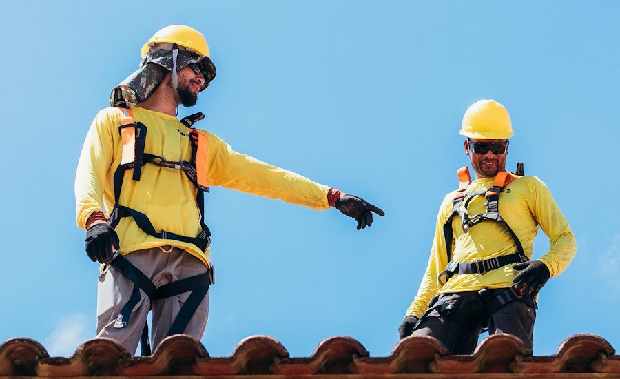 two-roofers-in-harnesses-on-tile-roof