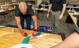 A roofing contractor installs peel-and-stick roofing underlayment