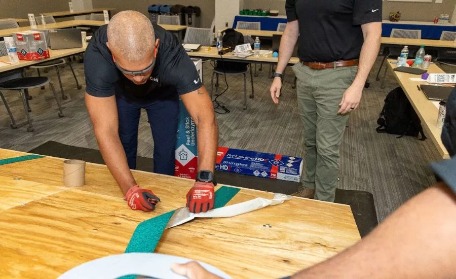A roofing contractor installs peel-and-stick roofing underlayment