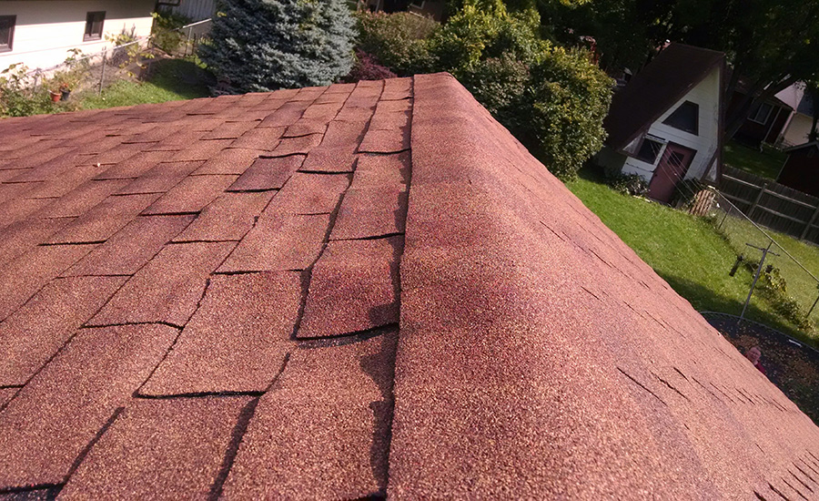 a roof with warped shingles