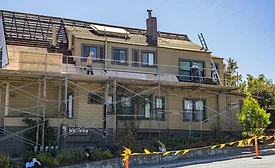 roofers-on-scaffolds-working-on-home