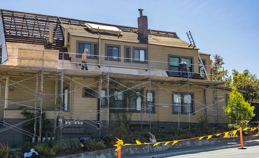 roofers-on-scaffolds-working-on-home