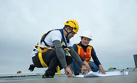 Two construction workers looking at plans
