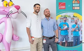 Bargain Block stars Keith Bynum and Evan Thomas pose together at an Owens Corning “Roof the Block” event, standing beside the Pink Panther mascot and event signage.