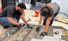 students installing shingles