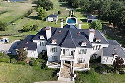 drone view of exterior of French Colonial home
