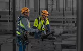 two-workers-in-safety-vests-and-harnesses