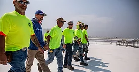 A roofing crew on a roof