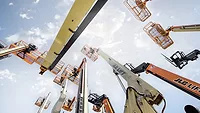 A level shot of various JLG booms looking upward