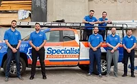 Specialist Roofing Repair team in front of work truck