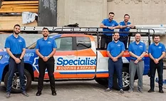 Specialist Roofing Repair team in front of work truck