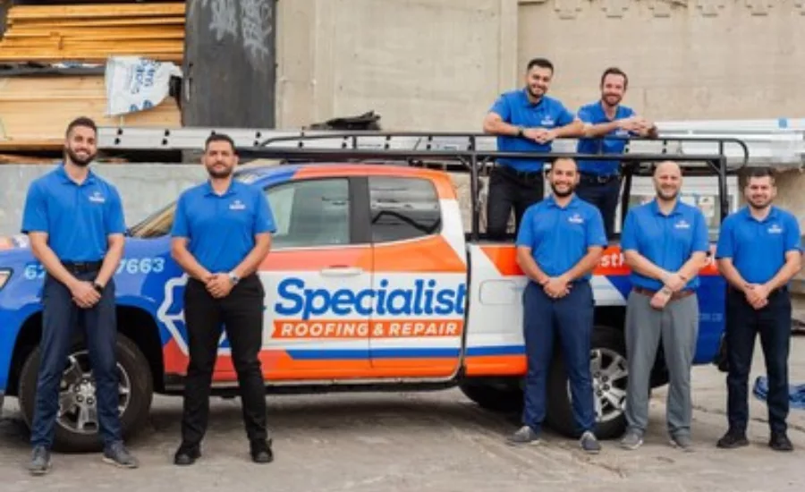 Specialist Roofing Repair team in front of work truck