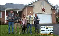 Burns & Scalo Roofing 2025 Donation.jpg group in front of donated roof