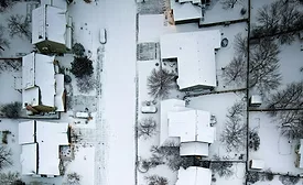 aerial image of snow-covered residential roofs 