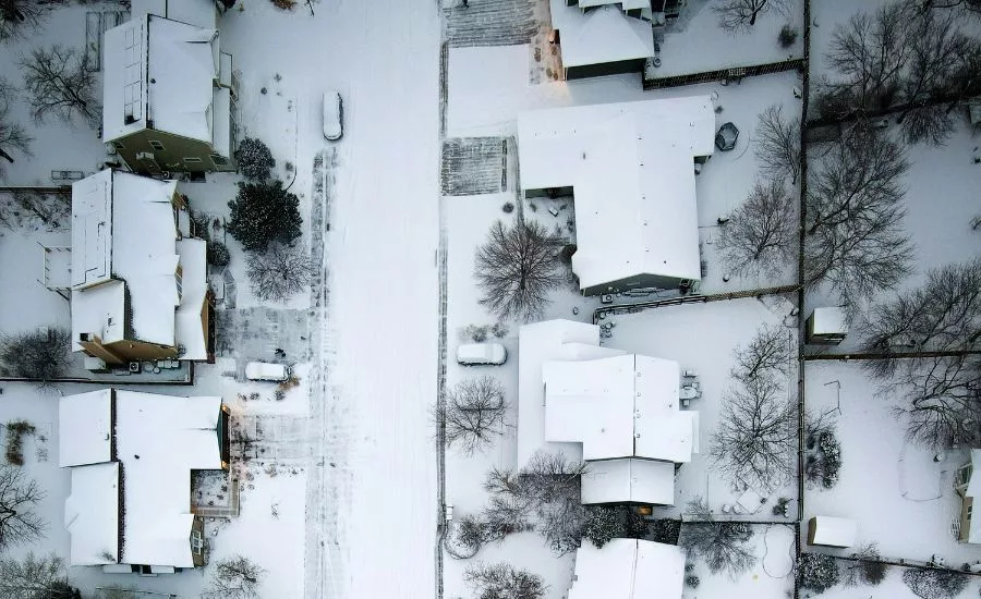 aerial image of snow-covered residential roofs 