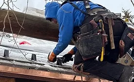 contractor installing snow guards