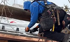 contractor installing snow guards