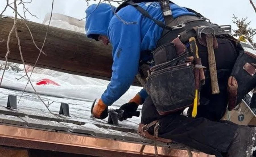 contractor installing snow guards