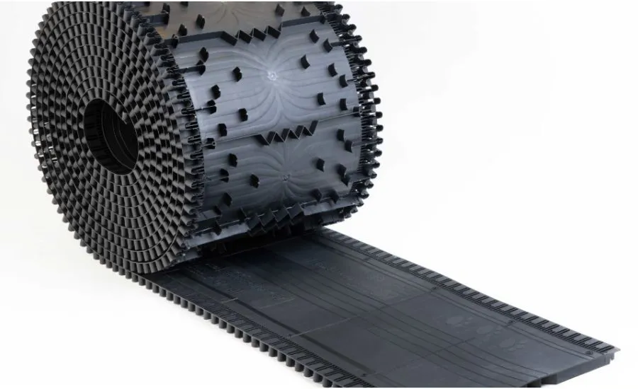 Black dimpled membrane roll unrolling on a white background.