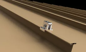  Silver clamp on a tan corrugated metal roof panel