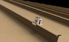  Silver clamp on a tan corrugated metal roof panel