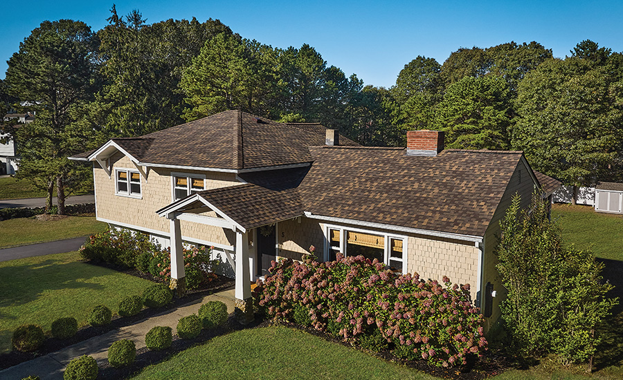 A residential roof with GAF Timberline shingles in Chestnut