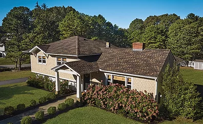 A residential roof with GAF Timberline shingles in Chestnut