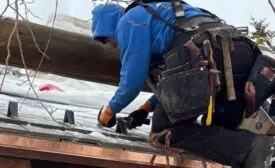 contractor installing snow guards