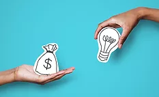 2 hands holding drawn art representing a money bag and a lightbulb